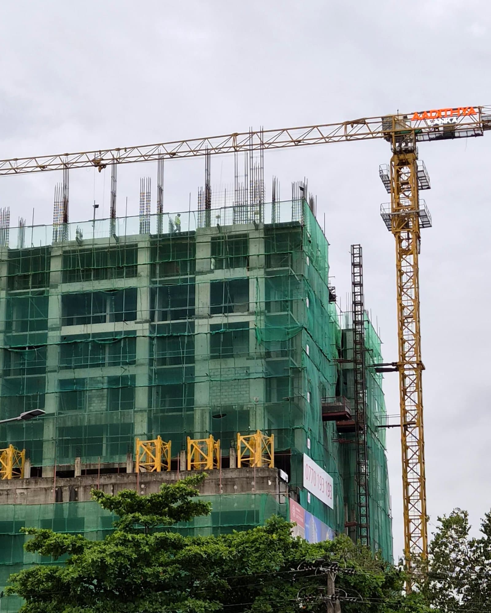 The tower rising on site, with the Aadithya Lanka crane above it